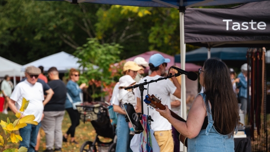 Person singing outside at an event