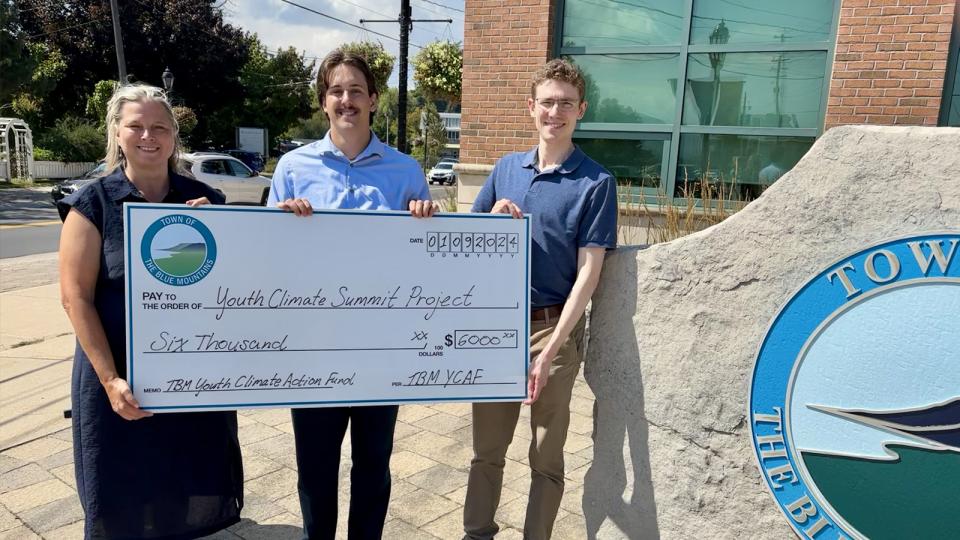 Mayor Andrea Matrosovs and Nick Cloet present cheque to grant recipient