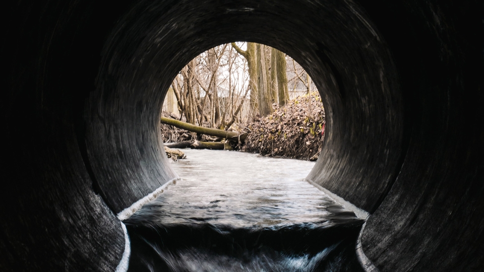 water flowing through an underground culvert