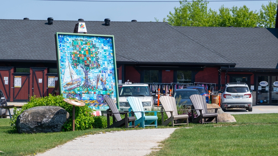 Muskoka chairs in front of Canada 150 mural