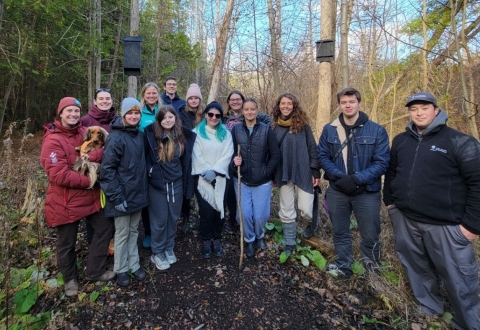 A group of students in front of the bat box they installed